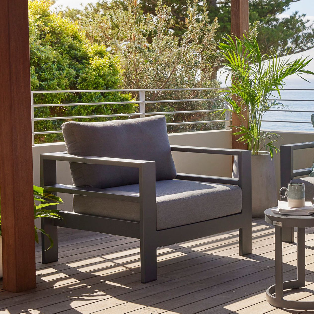 Albury outdoor furniture collection featuring outdoor chairs, aluminium outdoor furniture on a patio with a chair, table, and potted plant, covered with a protective cover.