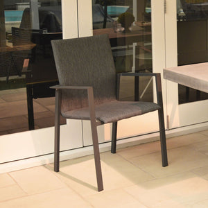 Aluminium Eden outdoor dining furniture, a durable outdoor chair sitting in front of a glass door.