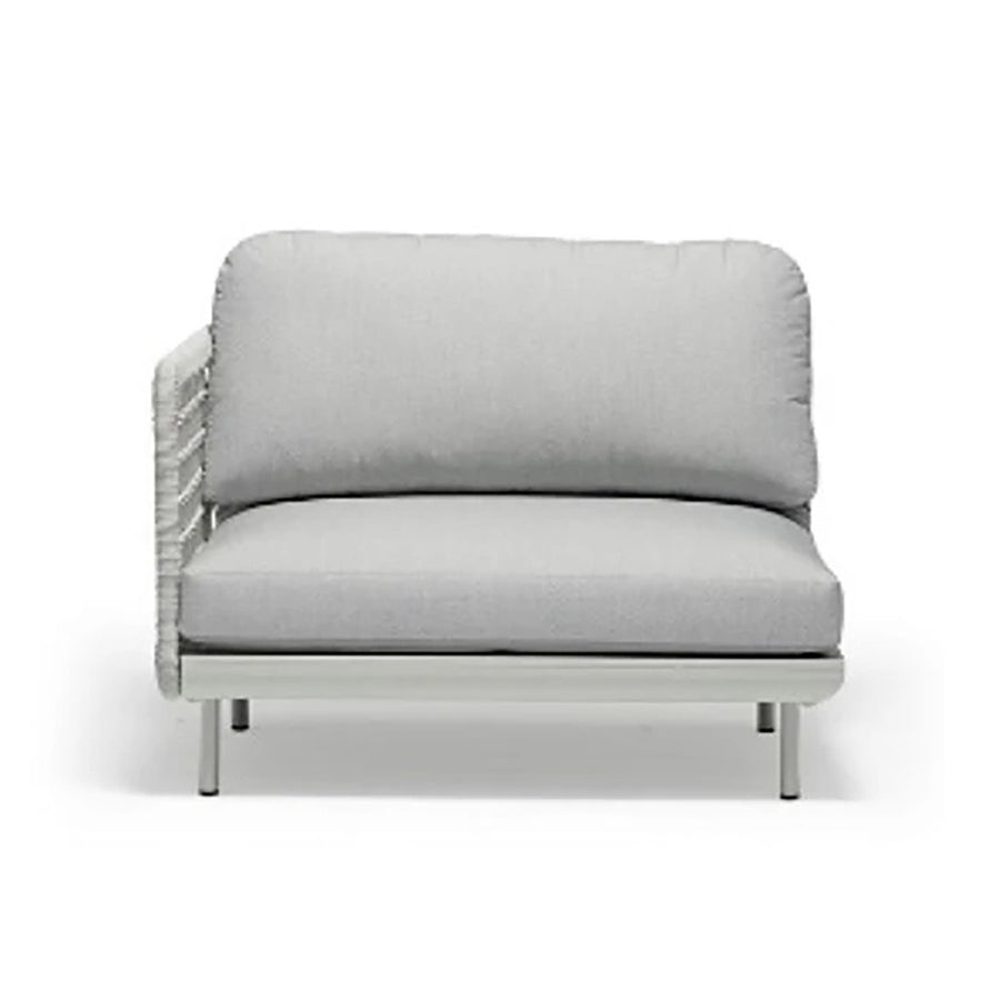 Outdoor furniture from the Colwood Collection featuring a wicker lounge chair, outdoor dining furniture, and a rope end chair with a light grey frame and cushion against a white background.