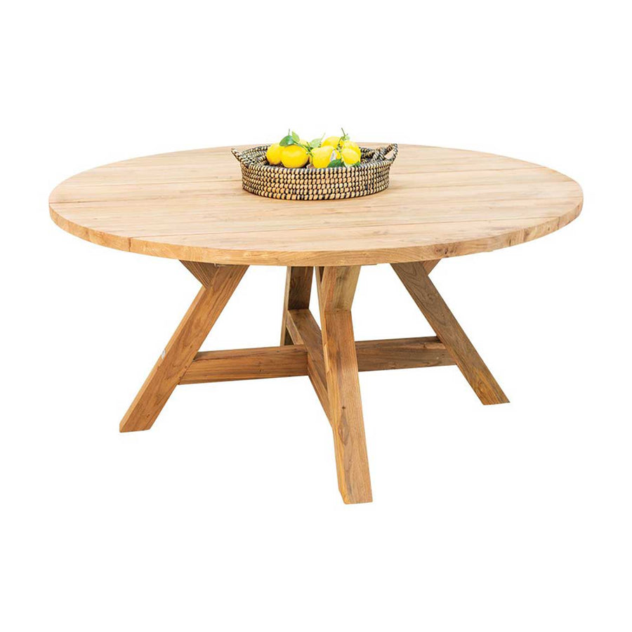 Outdoor furniture: A recycled teak round dining table with natural frame with a basket of fruits set against a white background.