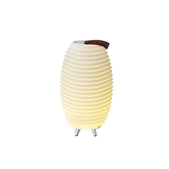 The Kooduu Synergy Bluetooth Speaker LED Lamp, turned on, emitting a warm soft yellow light, set against a plain white background. The brown leather handle is turned to the right side.