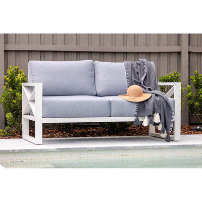Aluminium outdoor furniture set from Linear Lounge collection, featuring a 3-seater lounge with white frame and light grey cushions beside a pool.