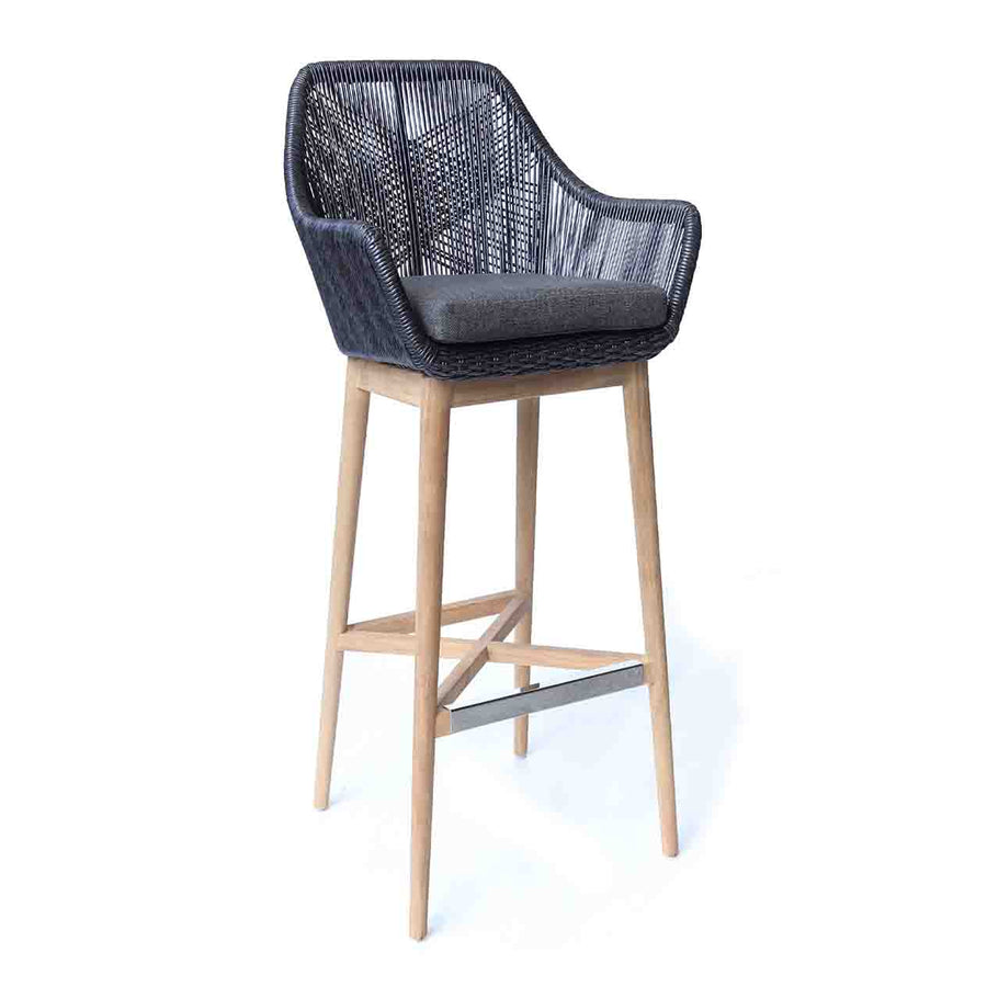 Black & grey wicker outdoor bar stool with teak legs displayed on a plain white background, viewed from a front angle.