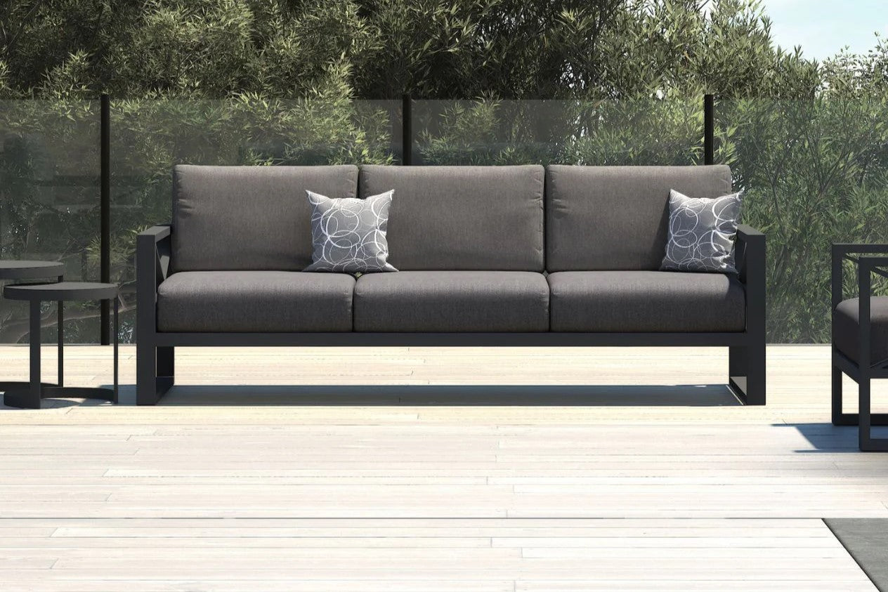 A contemporary 3 seater outdoor lounge featuring sleek lines and elegant dark grey cushions, perfect for stylish outdoor relaxation.