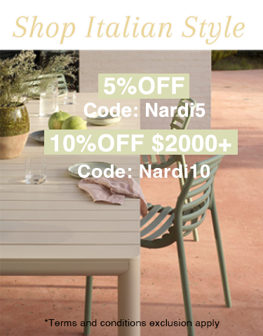 A vibrant outdoor setting featuring some amazing Nardi outdoor furniture pieces. There is a long black extension table and 10 yellow outdoor chairs on a wooden deck, set with food for a welcoming atmosphere.