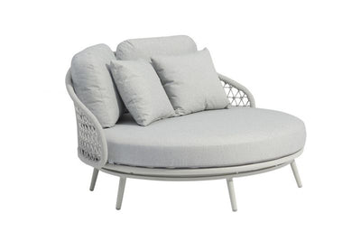  A Torino Outdoor Rope Daybed in light grey, with a curved metallic frame, rope accents, plush cushions, and matching throw pillows, ideal for upscale outdoor spaces.