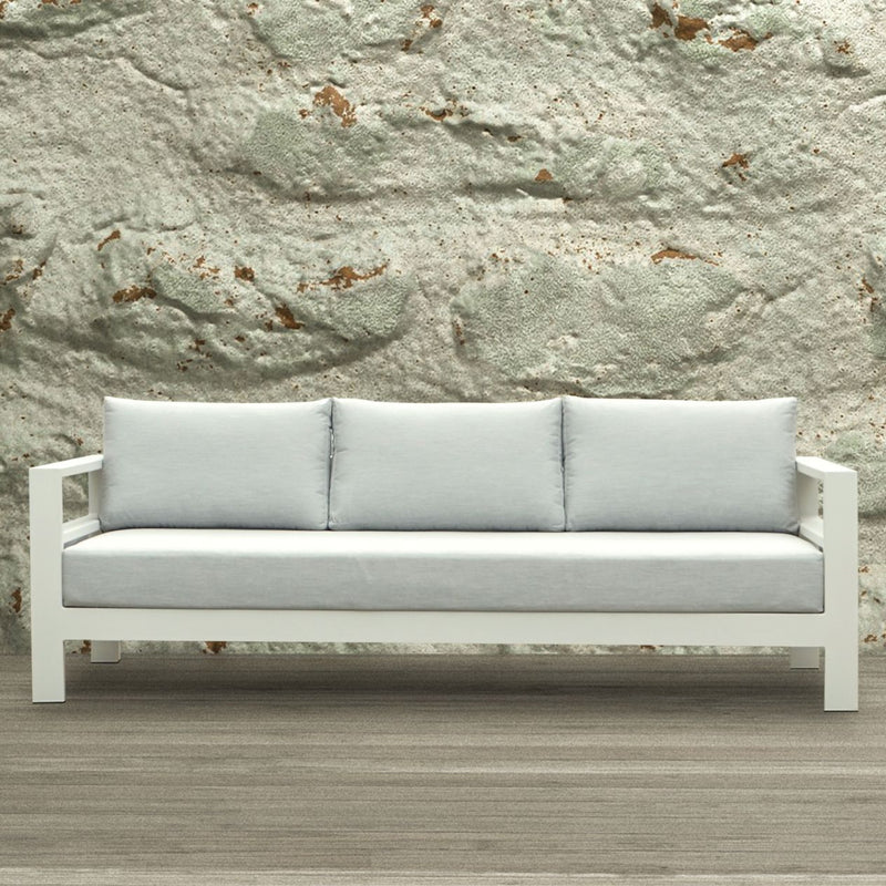 Albury outdoor furniture collection featuring a white couch, part of an outdoor lounge set, on a wooden floor, made with premium Spanish Agora fabric and aluminium outdoor furniture elements.