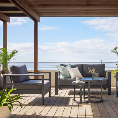 Albury outdoor furniture collection on a patio, including an outdoor lounge, armchair, and aluminium outdoor furniture with a table.