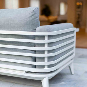 Alora outdoor furniture range featuring a white and gray couch, outdoor lounge, and rope chair on a tiled floor, designed for durability and comfort.