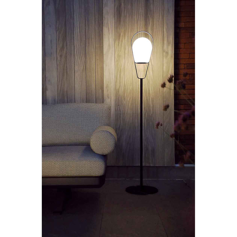 Grey and white Bobby Outdoor Aluminium Lamp glowing in an outdoor living area at night, enhancing the space with ambient lighting.