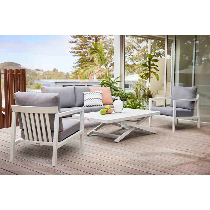 Bradford aluminum outdoor furniture set on a patio, featuring a sleek outdoor lounge chair, couch, and coffee table in charcoal and white.