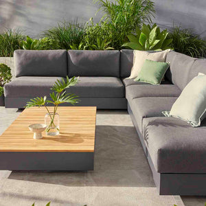 Charcoal and white Como sofa collection, a versatile outdoor balcony furniture, part of aluminum outdoor furniture range, featuring a couch and a coffee table on a patio.