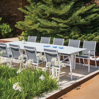 Outdoor furniture: An aluminium dining chair with teak arm, white frame, light grey textilene, and dining table.