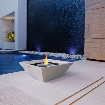 White square EcoSmart Nova 600 outdoor firepit set poolside in modern house.