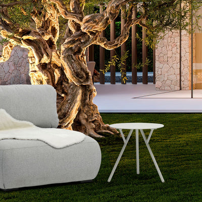 Aluminium outdoor furniture, Iowa coffee table in light grey, part of outdoor dining furniture set, next to a white couch on a lush green field.