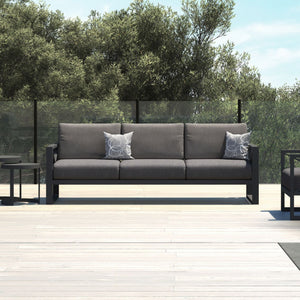 Aluminum outdoor furniture from Linear Lounge collection, including outdoor chairs and a couch on a wooden deck, perfect for outdoor lounging.