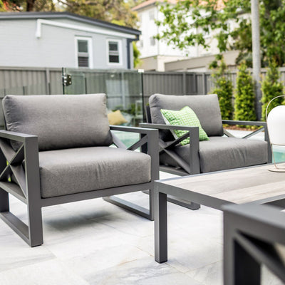 Aluminum outdoor furniture from Linear Lounge collection, including outdoor chairs and outdoor lounge, on a patio.