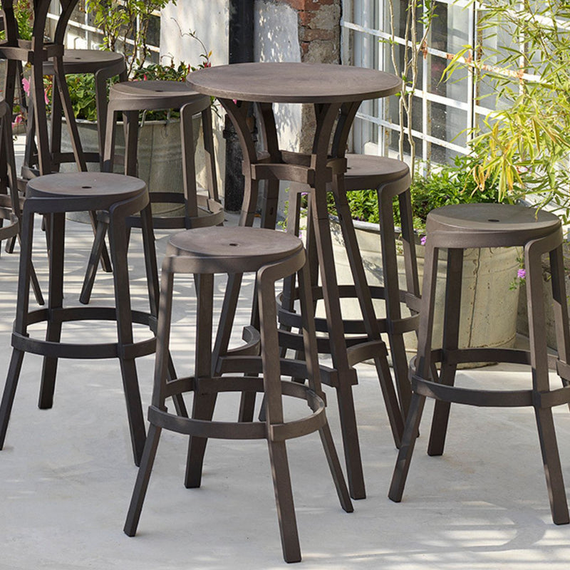 Outdoor dining furniture, Nardi Combo Bar Table with outdoor chairs on a cement floor.