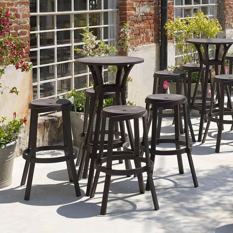 Stack Maxi Bar Stool by Nardi, a group of stools sitting on top of a cement floor, perfect for outdoor furniture needs.