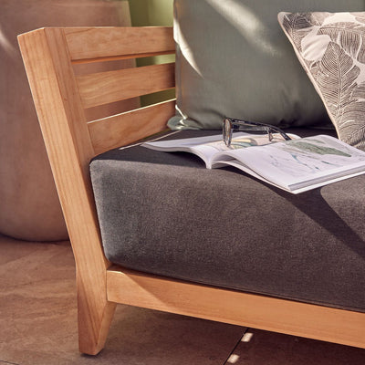 Outdoor furniture set with teak frame, charcoal and light grey cushions, perfect for creating a harmonious entertaining area.