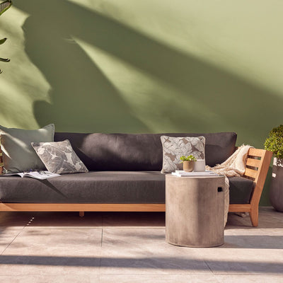 Outdoor balcony furniture set from The Ottawa family, featuring outdoor chairs, a 3-seater outdoor lounge, and a daybed, all made of durable teak wood and Sunproof fabric, placed on a patio next to a potted plant.
