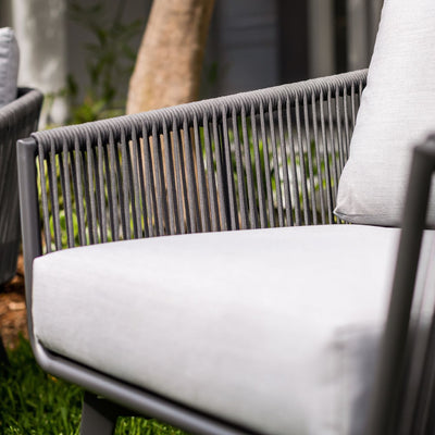 A close-up on the side of a modern outdoor armchair with charcoal-coloured rope weaving on the backrest and seat.