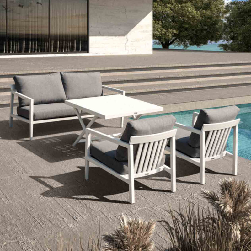 Bradford aluminum outdoor furniture set, featuring a sleek outdoor lounge chair and sofa in charcoal and white, placed on a patio next to a pool.