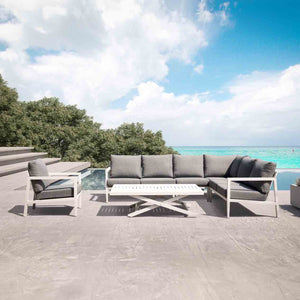 Bradford aluminium outdoor furniture set on a patio, including a sleek charcoal or white couch, coffee table, and chairs, perfect as outdoor balcony furniture.