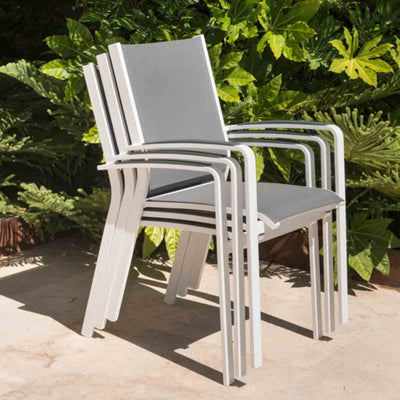 White Cosmo outdoor dining furniture, aluminium outdoor chairs on a cement patio