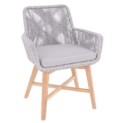 Outdoor furniture: A wicker dining chair with natural frame, light grey fabric, white wicker set against a white background.