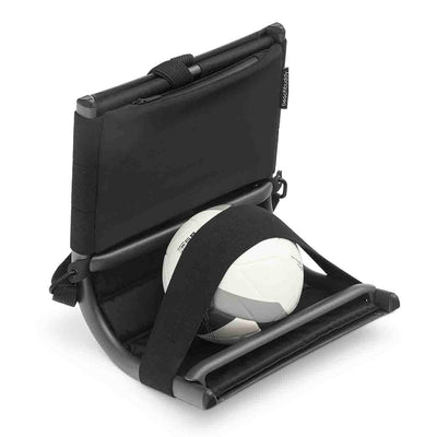 The black aluminium 'Beach Buddy' outdoor backrest, folded into a compact form and holding a football, displayed on a plain white background. The design functions as a portable sun lounger with curves that provide support and comfort while on the go.