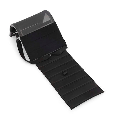 The black, aluminium 'Beach Buddy' outdoor backrest which functions as a portable sun lounger. Its curves provide support & comfort on the go. It is displayed on a plain white background, viewed from a top-down angle.
