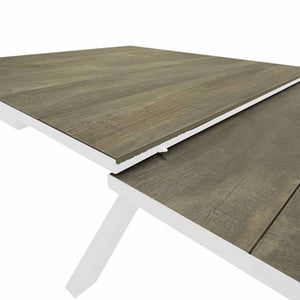 Close-up of a white 201/261 cm extendable ceramic outdoor dining table from the 'Clifton' range, ideal for alfresco furniture setups, displayed on a plain white background.