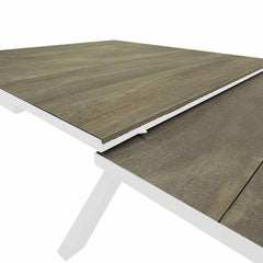 Close-up of a white 201/261 cm extendable ceramic outdoor dining table from the 'Clifton' range, ideal for alfresco furniture setups, displayed on a plain white background.