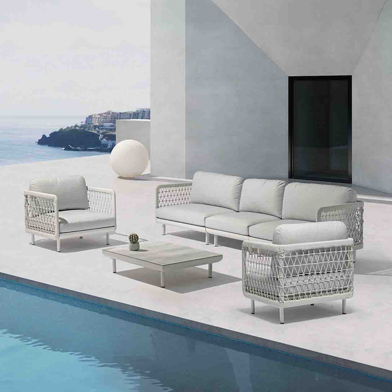 Outdoor furniture: A rope 4-seater lounge with light grey frame and cushions, coffee table set by the poolside.