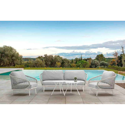 Light grey 2-piece round coffee table set, a 2-seater rope lounge, and a matching armchair, all arranged poolside on a sunny summer day. This elegant outdoor seating setup is a perfect example of alfresco furniture, designed for comfort and relaxation in an outdoor living space.