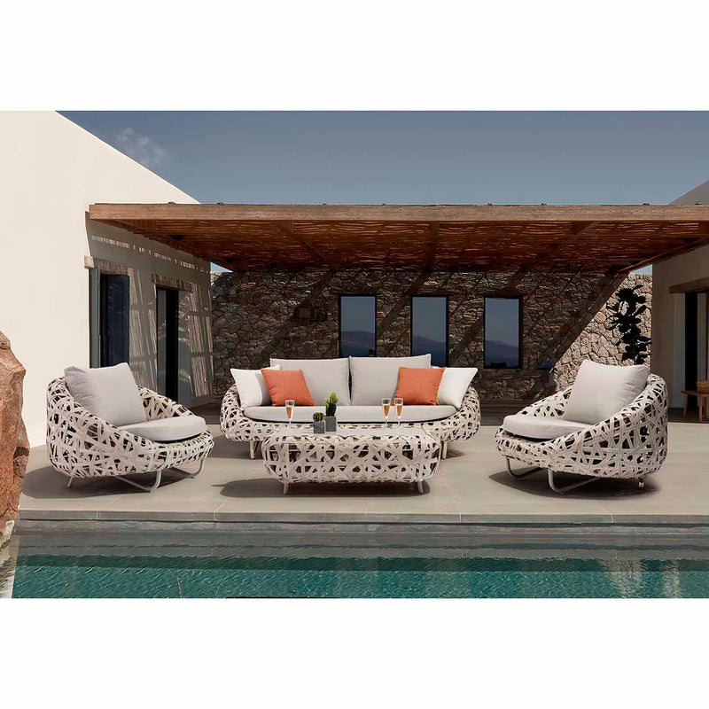 Poolside setup featuring two wicker lounges, a two-seater lounge, and a matching coffee table, all in a modern European outdoor space, perfect for alfresco furniture style.