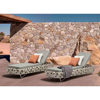Two Rhodes Outdoor Wicker Sunlounges, styled with orange, white, and grey cushions, set in the outdoor area of a modern European house, showcasing outdoor living.
