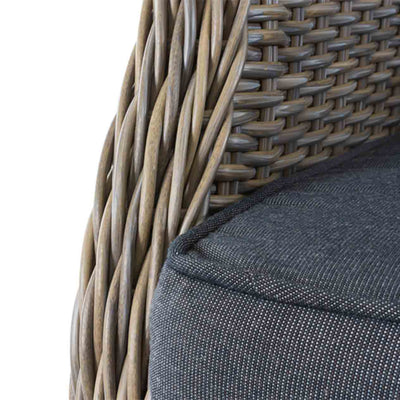 Close-up on the grey cushioned seating of a brown wicker 'Darwin' outdoor dining chair, great for balcony relaxing.