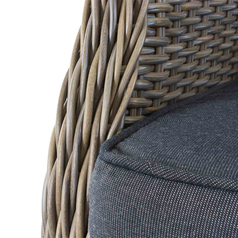 Close-up on the grey cushioned seating of a brown wicker &