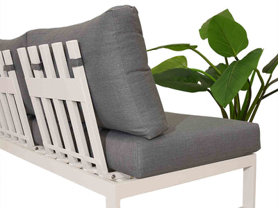 Versatile Denver outdoor furniture set in Charcoal or White, including aluminum outdoor lounge chair, one-seater, corner, and three-seater sofa, next to a white bench with a plant on top of it.
