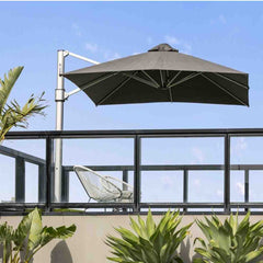 Black and grey outdoor umbrella on an outdoor deck area, providing shade for two outdoor chairs.