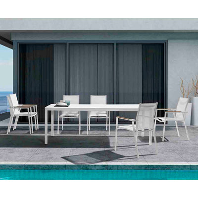 White Ella Outdoor Aluminium Dining Table with Ceramic Glass Top surrounded by six matching aluminium patio chairs, all set poolside on a hot summer day, offering a stylish and comfortable outdoor dining space.
