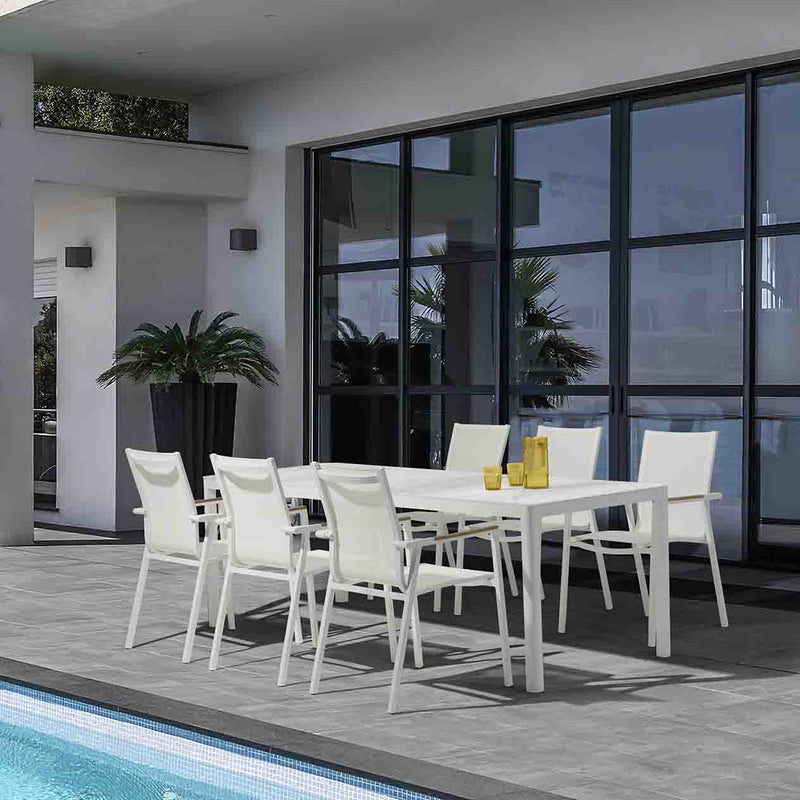 White Ella Outdoor Aluminium Dining Table with Ceramic Glass Top surrounded by six matching aluminium patio chairs, set poolside during a hot summer day. The table is decorated with yellow glasses of water, adding a vibrant touch to the alfresco dining experience.