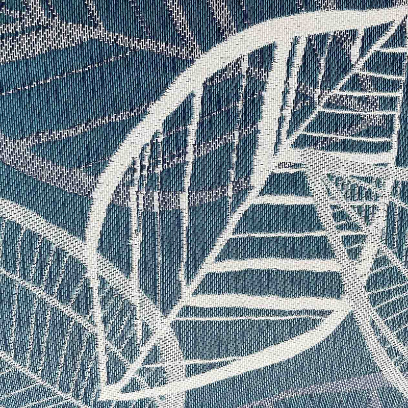 Close up on the blue, grey, and white lakeside-inspired leaf pattern design on an outdoor scatter cushion, perfect for outdoor furniture setups.