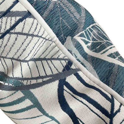 Close-up on the side of a blue, grey, and white outdoor scatter cushion with a lakeside-inspired leaf pattern design, perfect for outdoor furniture setups.