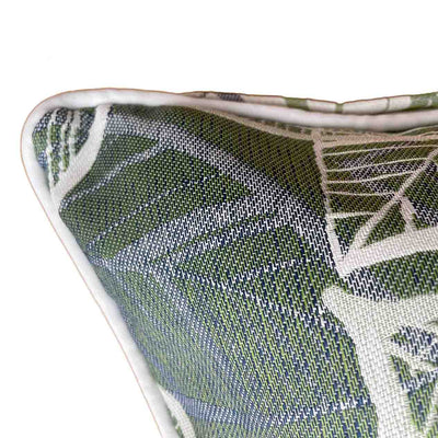 Close up on the corner of an outdoor scatter cushion with a white, grey, and green Amazon-inspired leaf pattern design, perfect for outdoor furniture setups.