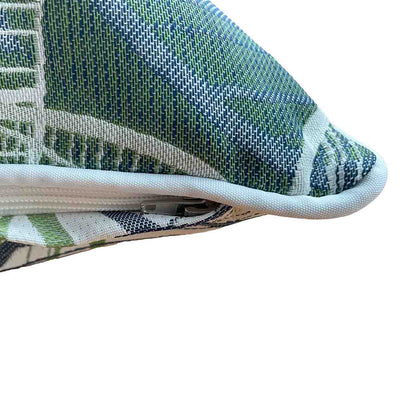 Close up on the corner of an outdoor scatter cushion with a white, grey, and green Amazon-inspired leaf pattern design, perfect for outdoor furniture setups.