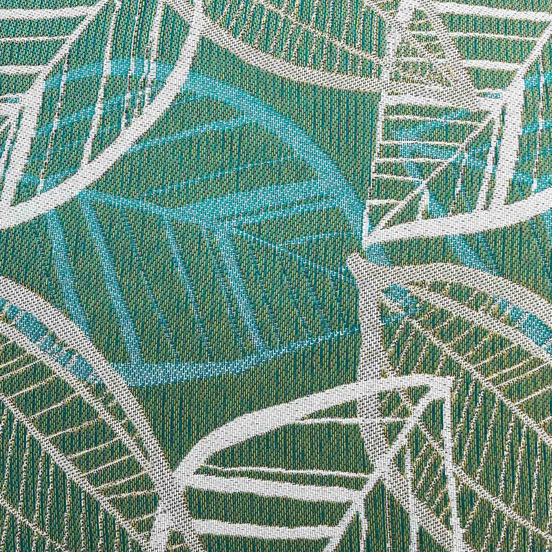 Close-up on the green, blue, and white Citron-inspired leaf pattern design on an outdoor scatter cushion, perfect for outdoor furniture setups.