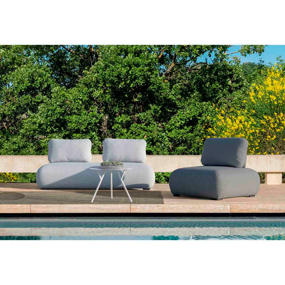 Light grey Iowa 2-seater upholstered lounge, a single upholstered lounge, and a matching round aluminium coffee table arranged poolside for three people. Set on a sunny summer day with lush greenery in the background, this stylish setup offers the perfect example of outdoor living, ideal for relaxing and enjoying the surroundings.
